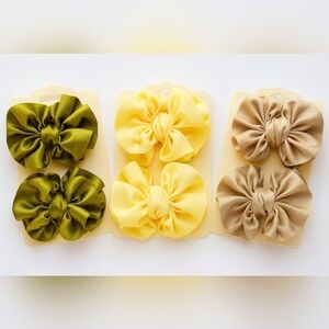 Set Of 3 Pairs Of Ribbon Bows In Olive Green, Soft Yellow And Beige.